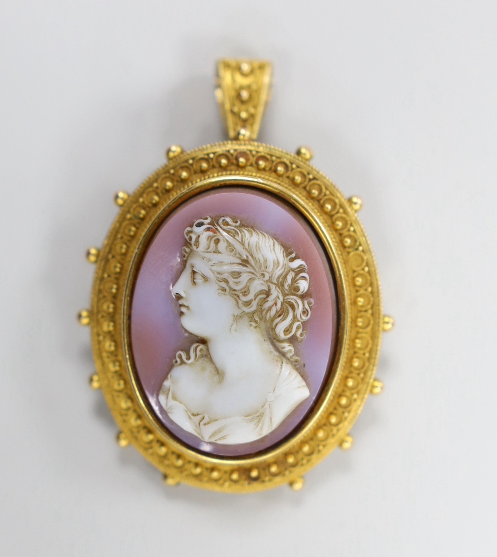 A Victorian yellow metal and hardstone cameo set oval pendant brooch (pin missing) with cannetile work decoration and engraved inscription verso, the stone carve with bust of a lady to dexter, overall 55mm, gross weight